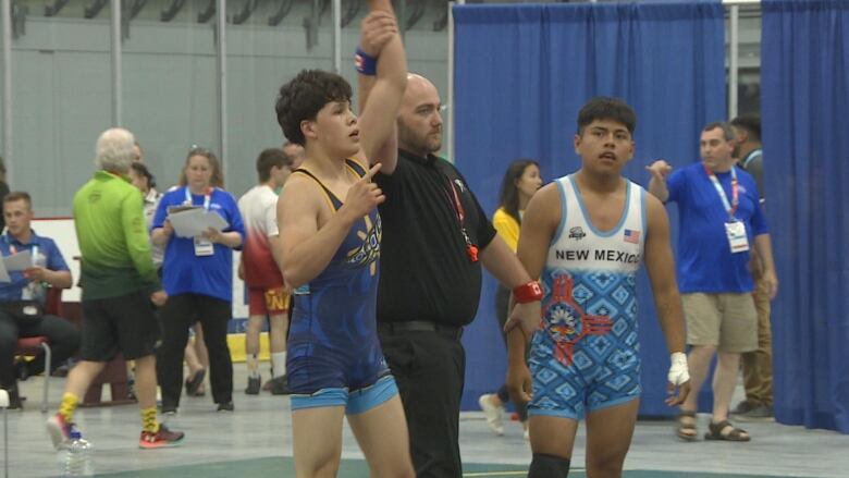 Maddex McGrath holds his arm up in victory following a wrestling tournament at the North American Indigenous Games in Halifax.