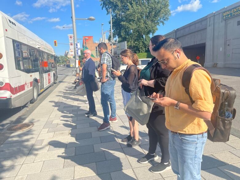 People wait in line for the bus.