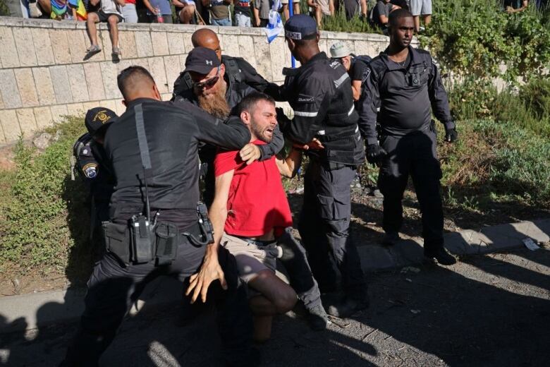 Security forces detain a demonstrator.