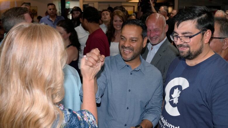 A man cheering within a group of people.