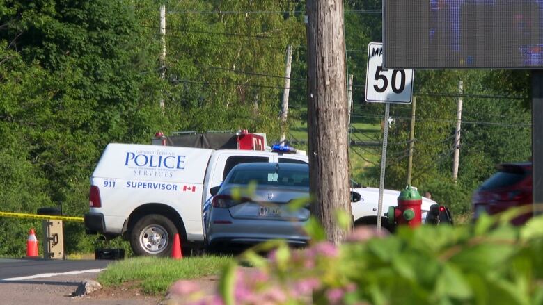 Charlottetown police van blocking road along with police line tape.