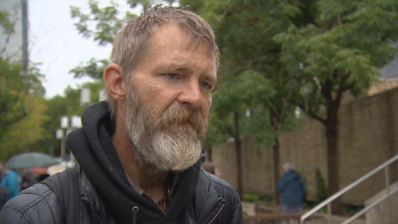 Man with beard speaks to CBC News outside Churchill Square.