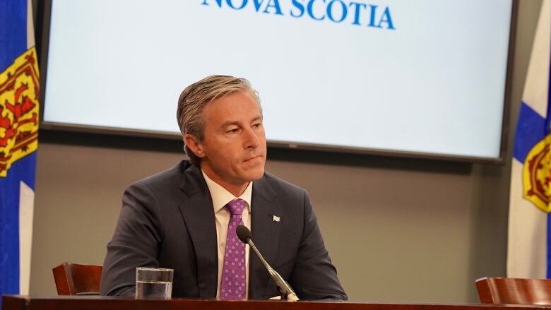 A man sits at a podium.