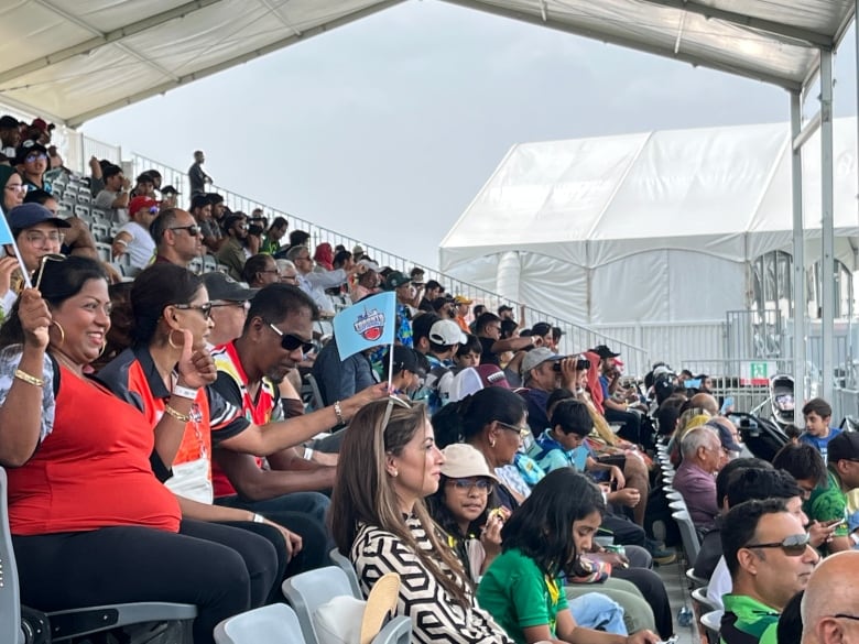 Cricket fans take in a match between the Mississauga Panthers and Toronto Nationals at the Global T20 tournament in Brampton on July 26, 2023.