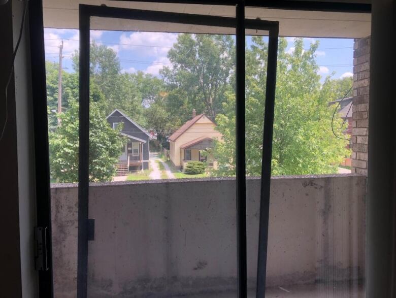 Ishaque's Southeast facing window and balcony, which she leaves open during the day to try and stay cool without air conditioning. 