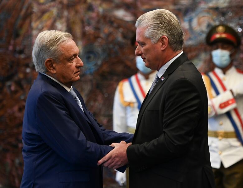 Cuban president Miguel Diaz Canel, right, shakes hands with his Mexican counterpart Andres Manuel Lopez Obrador at Revolution Palace in Havana, Cuba on Sunday, May 8, 2022.