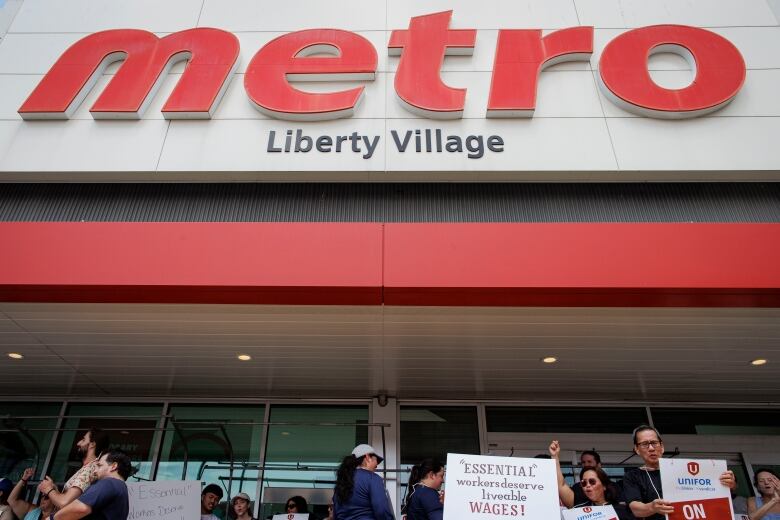 Unionized workers maintain a picket line outside a Metro grocery store, in Toronto, on July 31, 2023.