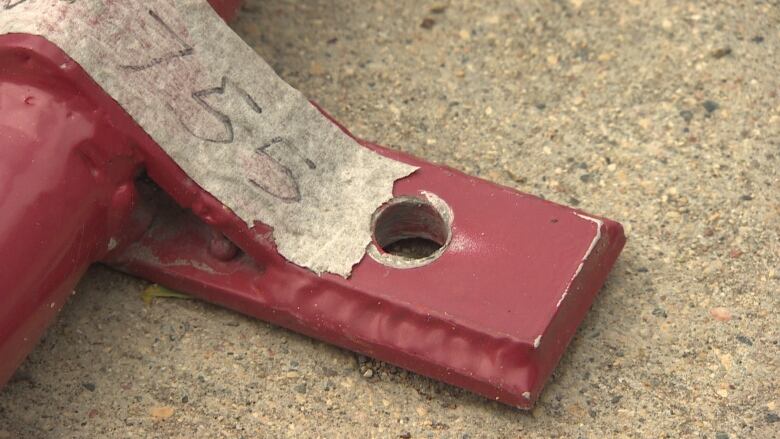 The bottom of a bike rack on Corydon Avenue missing a bolt that secures it to the ground. 