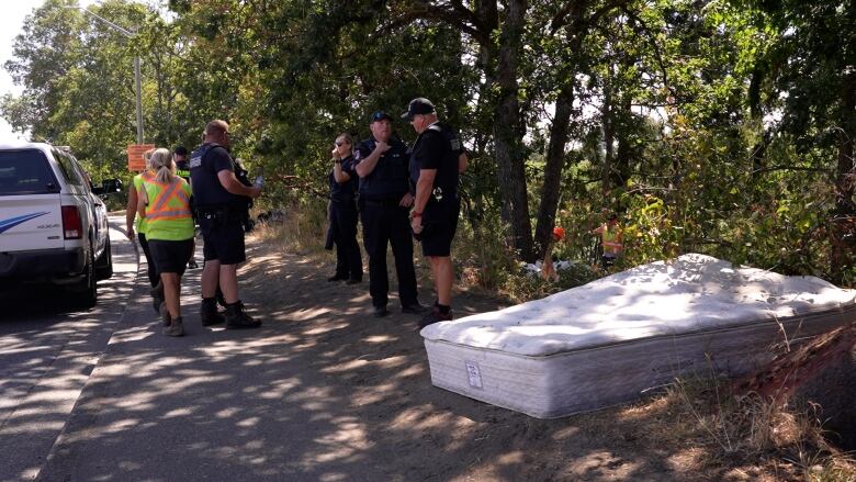 Nanaimo's CSO officers oversee encampment clean up at the Milestone River on Aug. 1.