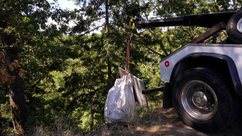 A tow truck was used to lift larger items out of the encampment. 