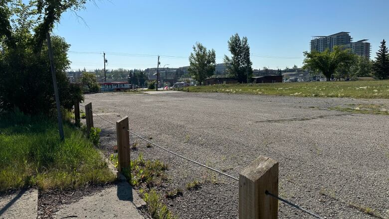 A shot of a road. A passing C Train can be seen in the background.  