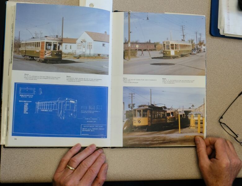 a Book containing images of streetcars is on a table open 