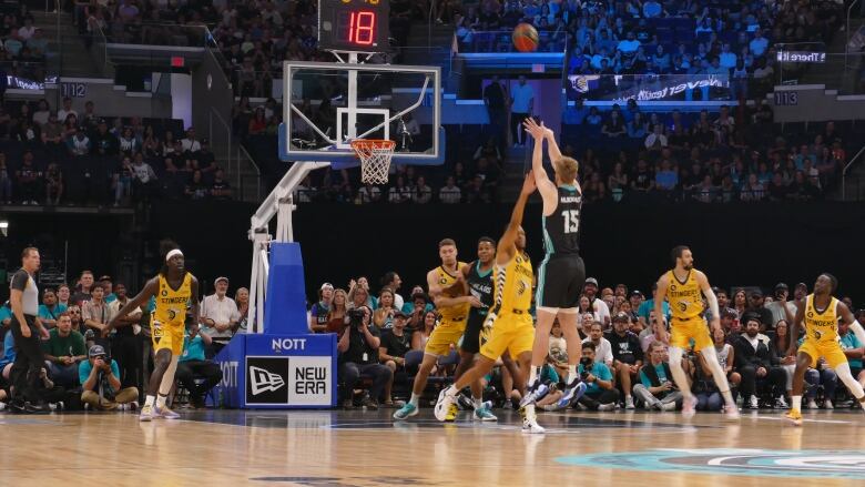 A basketball player shots the game during a game.