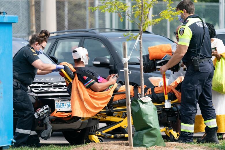  Toronto Paramedics treat a patient at the scene of a protest that turned violent in Earlscourt Park in Toronto, on Saturday, Aug. 5 2023.