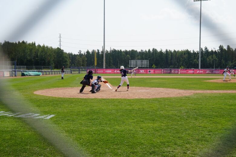 People play baseball outside.