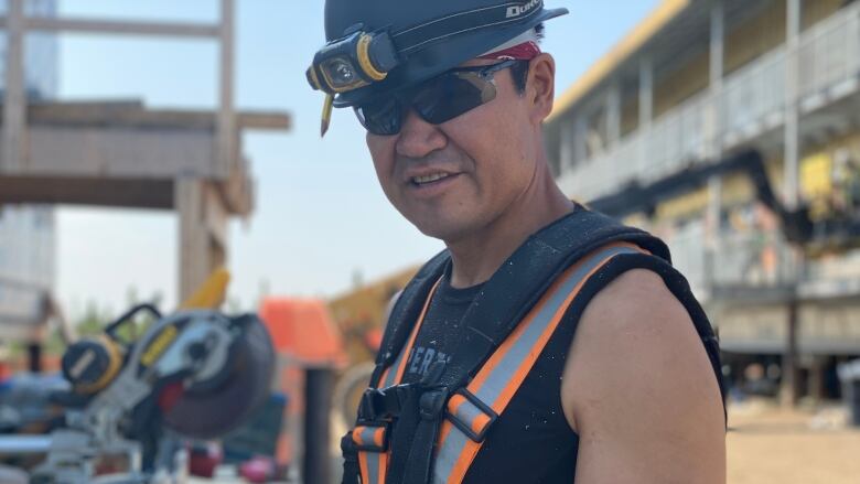 A construction worker stands on a construction site.