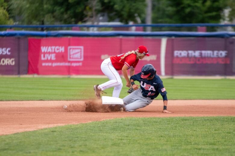 A player slides into second base during a baseball game.