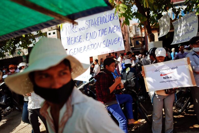 Workers at a factory that makes garments for Nike protest outside their union office in Cambodia.