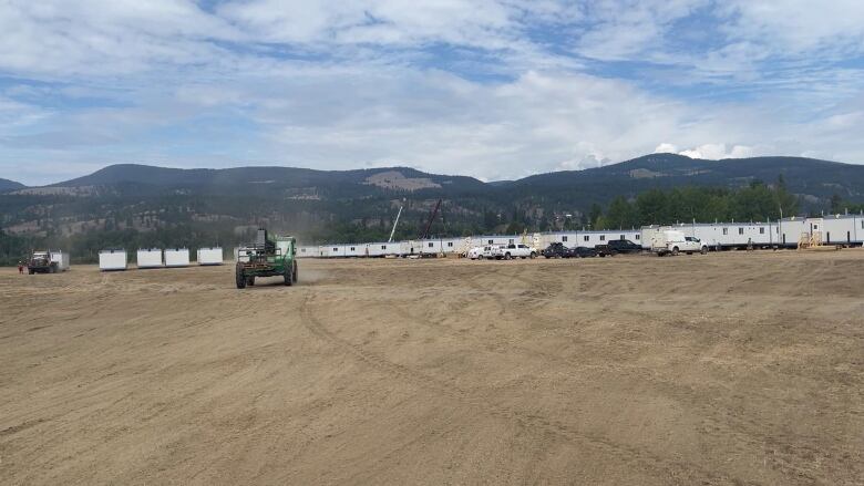 A row of trailers and heavy equipment.