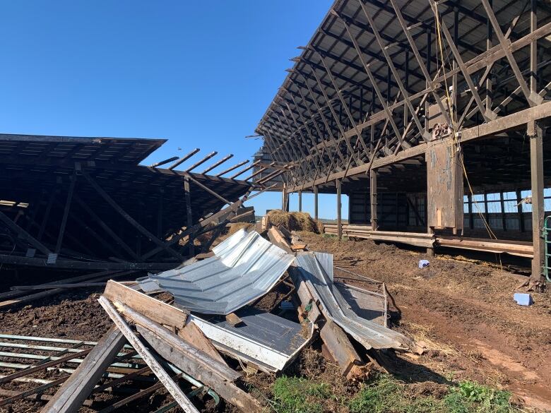 Damaged barn in Kingston, metal roof lifted off. 