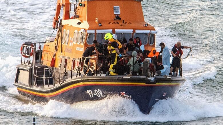 People are seen onboard a rescue boat.