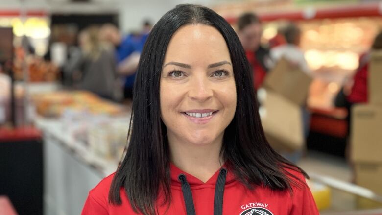 A brunette woman smiles for the camera.