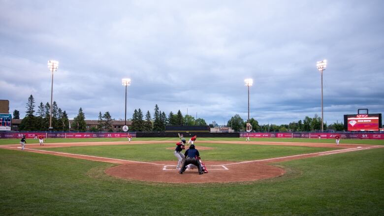 A baseball game at an outdoor stadium.