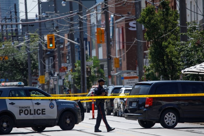 First responders are pictured at the scene of a daytime shooting near the intersection of Queen St. and Carlaw Ave., in Toronto on July 7, 2023.