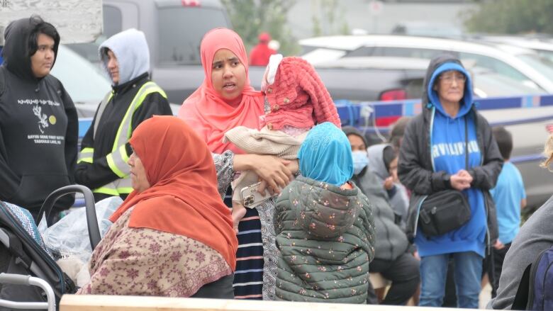 People in head scarves lined up for flights