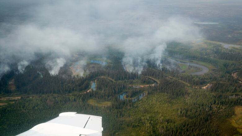 A small wildfire burns south of Enterprise, N.W.T.