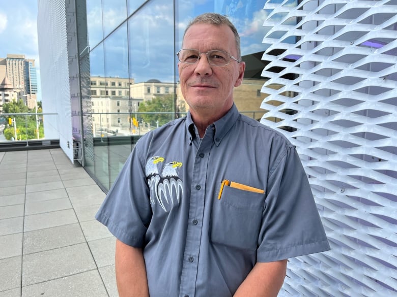 A man poses for a photo outside the Ottawa Art Gallery.