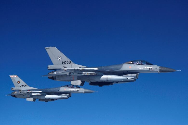 A file photo shows Netherlands Air Force F-16 fighters jets in flight during a demonstration for media in July 2023.