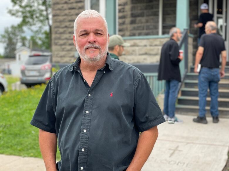 Man standing outside house