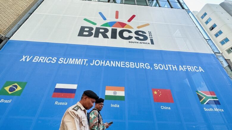 People walk past the Sandton Convention Centre, which will host the upcoming BRICS Summit, in Johannesburg, South Africa August 19, 2023