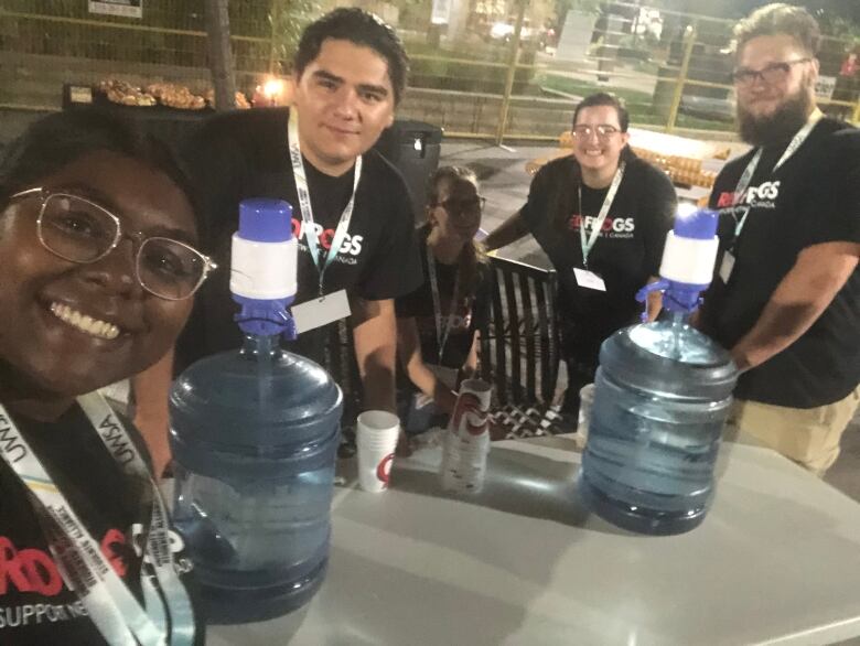 Latchman alongside Red Frogs volunteers at the University of Windsor's Welcome Week in 2022, displaying their 