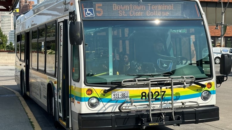 A Transit Windsor bus is shown parked at the curb of the downtown terminal.