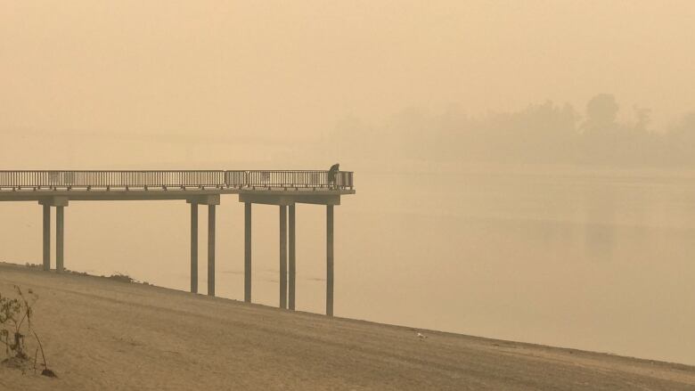 A man stands on a lookout at Riverside Park in Kamloops B.C. on Monday Aug. 21, 2023.