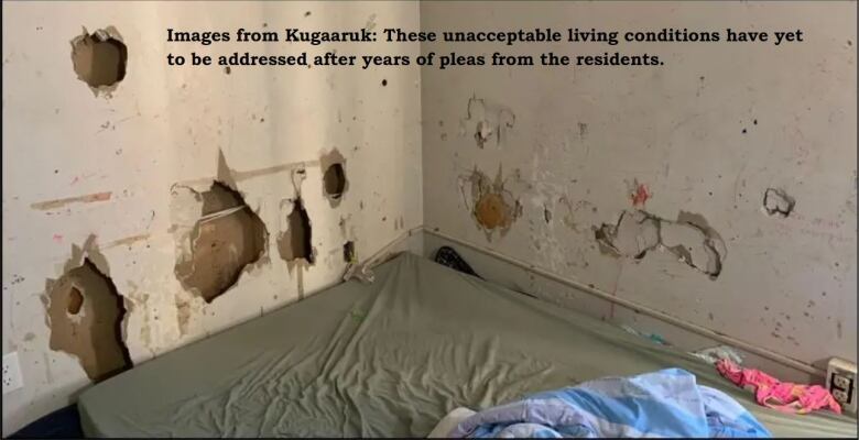 A room with damaged, unpainted drywall full of holes. Electric wiring is seen through the holes.