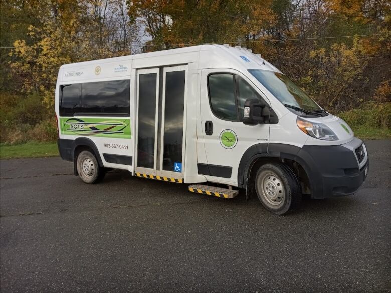 A large white travel van with doors on the side.