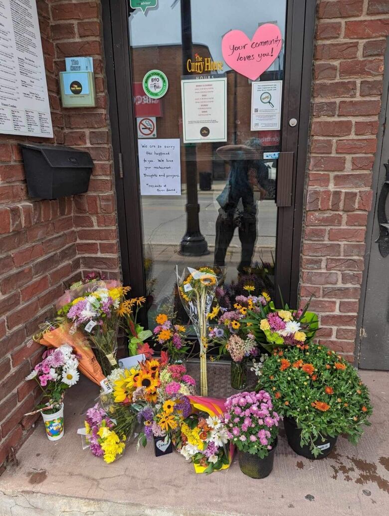 Flowers and messages at the door of a restaurant