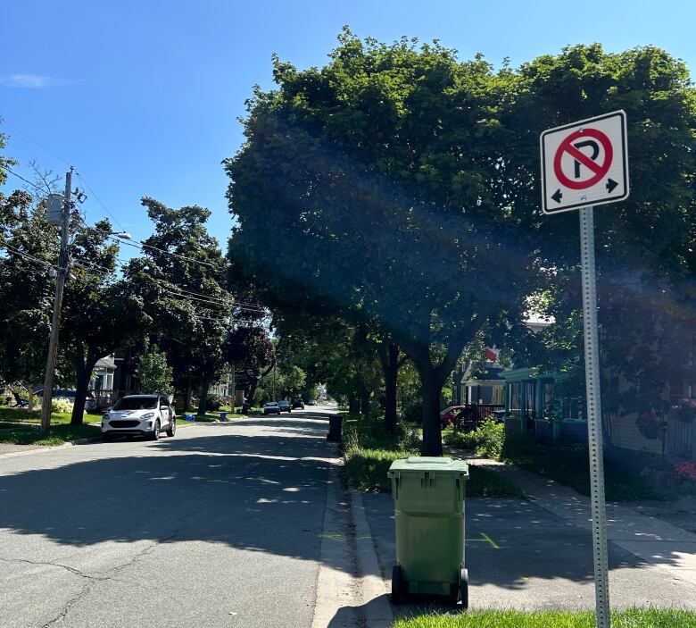 A street with a no parking sign on a pole on the right