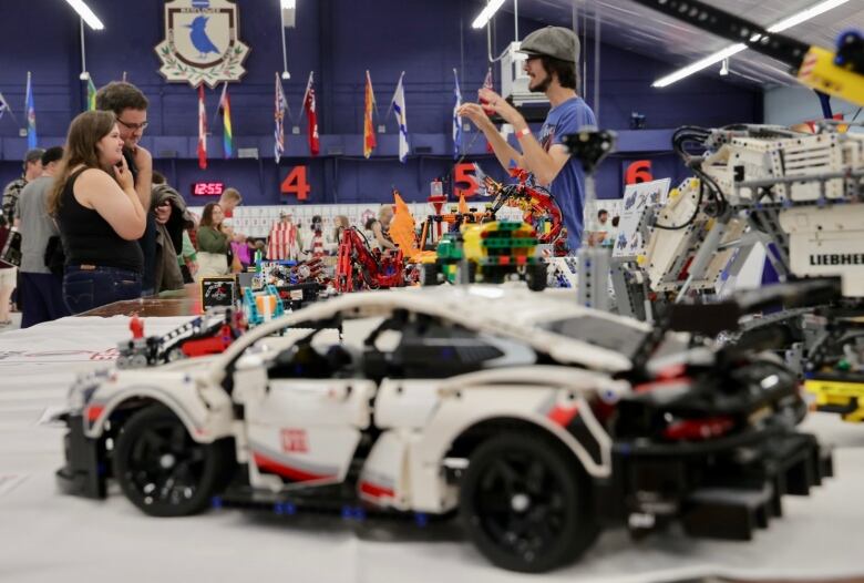 One of the Lego builders stands in front of his work while speaking to visitors of the event. 