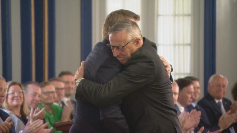 Don Morgan, the longtime MLA for Saskatoon Southeast, hugs Premier Scott Moe. Morgan is not in cabinet for the first time 16 years, after announcing he won't be running in next year's provincial election.