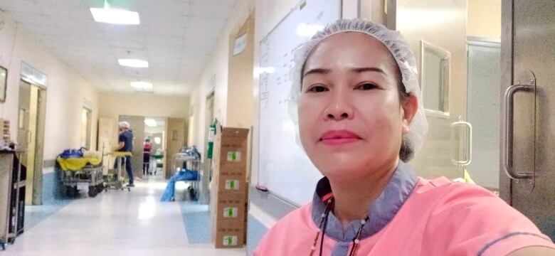 A woman poses for a selfie in a hospital.