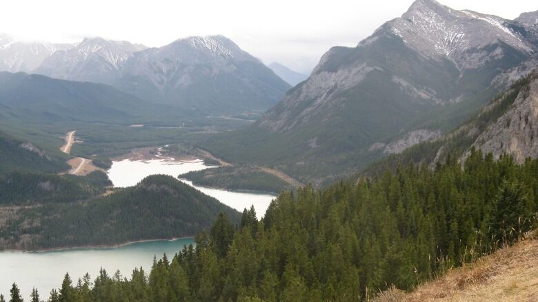 Mountains are seen past a lake. 