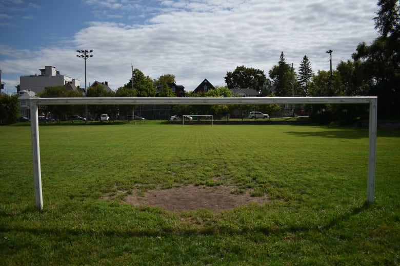 A soccer field in a park.