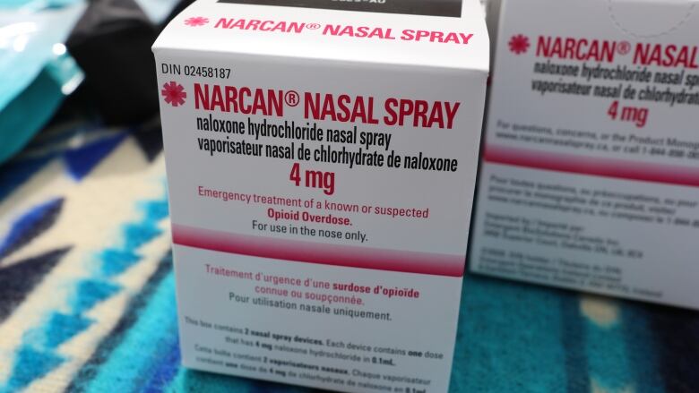 A photo of a white box containing Narcan nasal spray, according to a label on the box. 