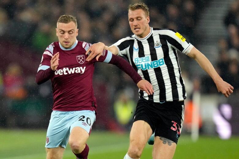 Jarrod Bowen challenges Dan Burn for the ball during an English Premier League soccer match in April 2023.