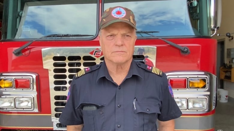 Man standing infront of a fire truck