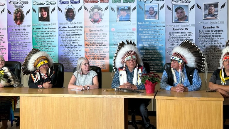 Chiefs and leadership sit at a table in front of a room